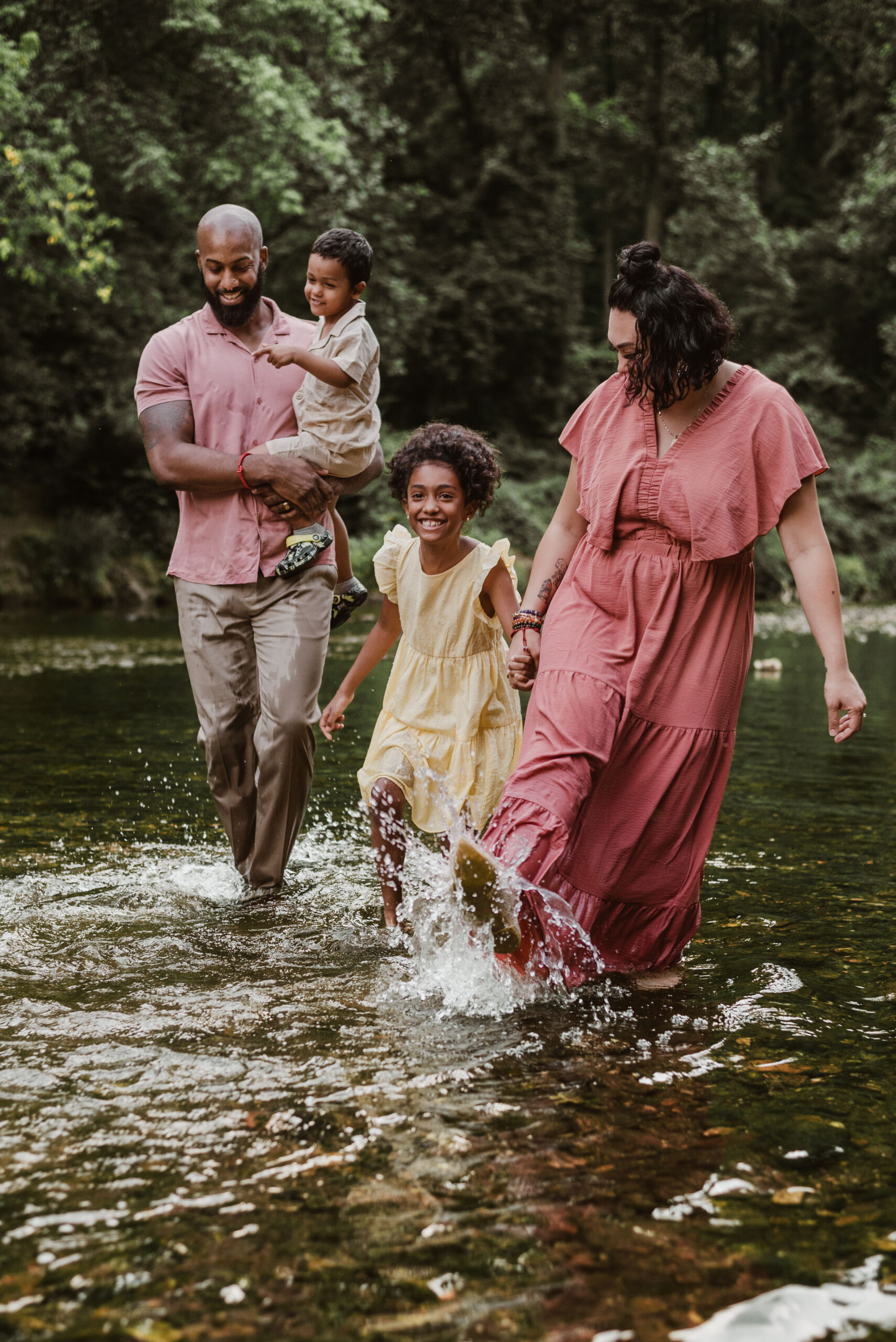 Family of 4 splashing in the river and having fun for family summer mini session