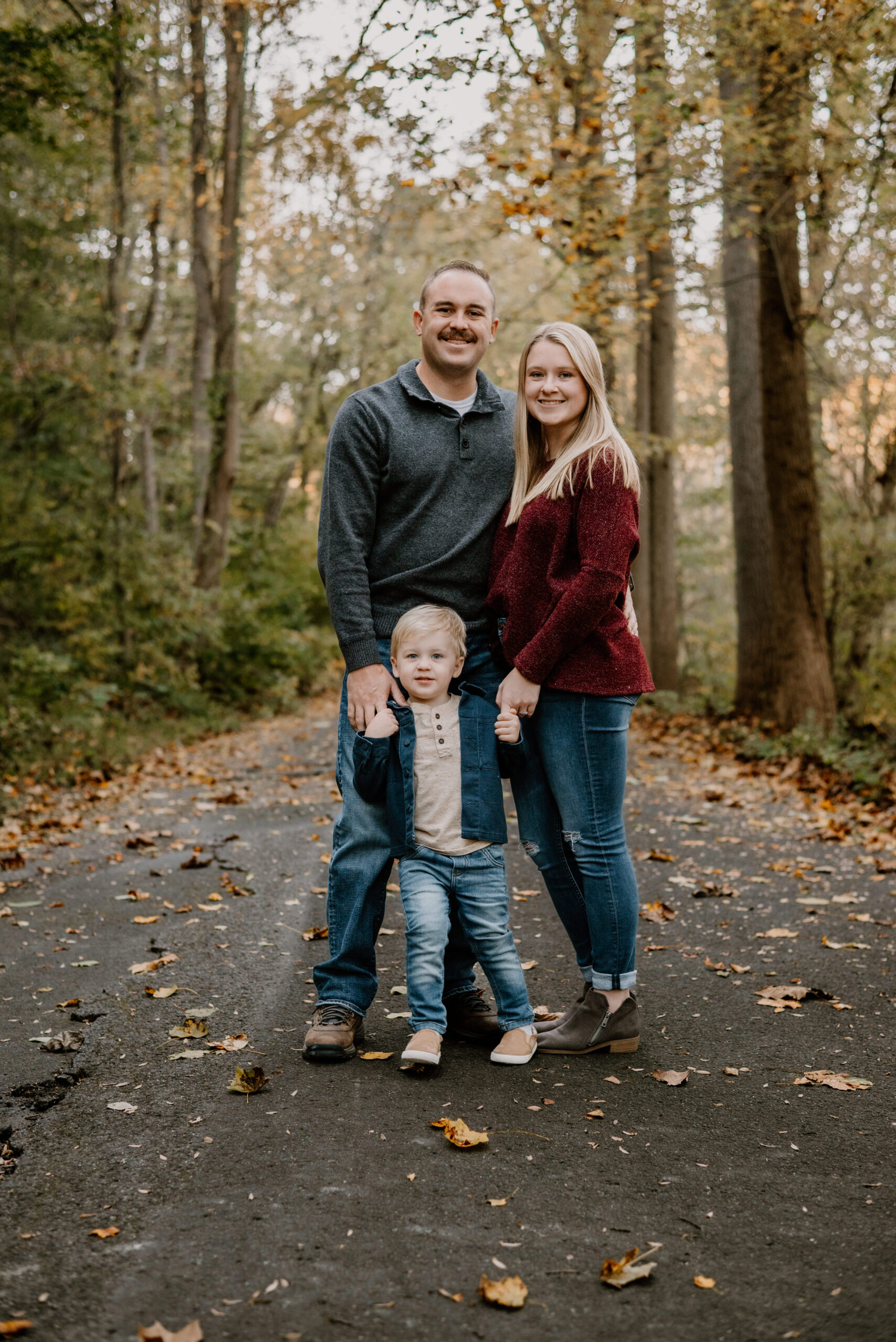 Family enjoying a fun fall mini photography session in Halethorpe, surrounded by vibrant autumn leaves, capturing genuine smiles and warm moments. Perfect for families seeking affordable, high-quality memories in Maryland.