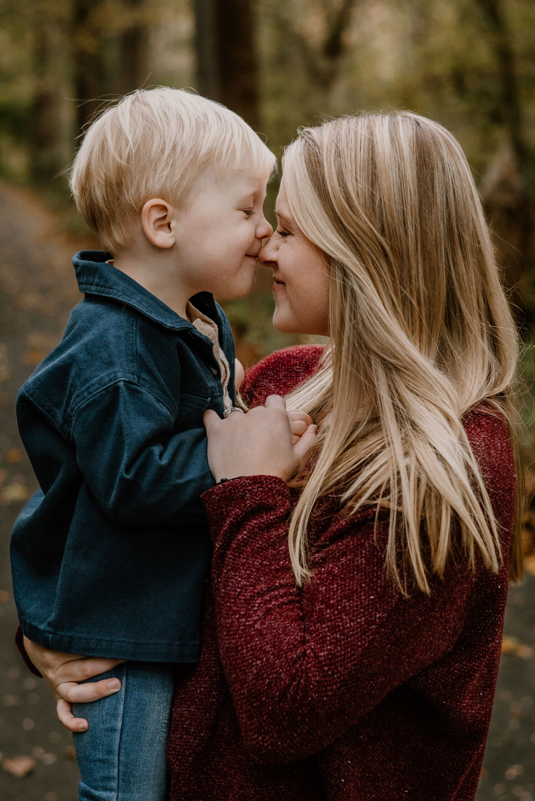 A scenic autumn family photography session in Baltimore, Maryland, capturing vibrant fall foliage as a backdrop for timeless memories.