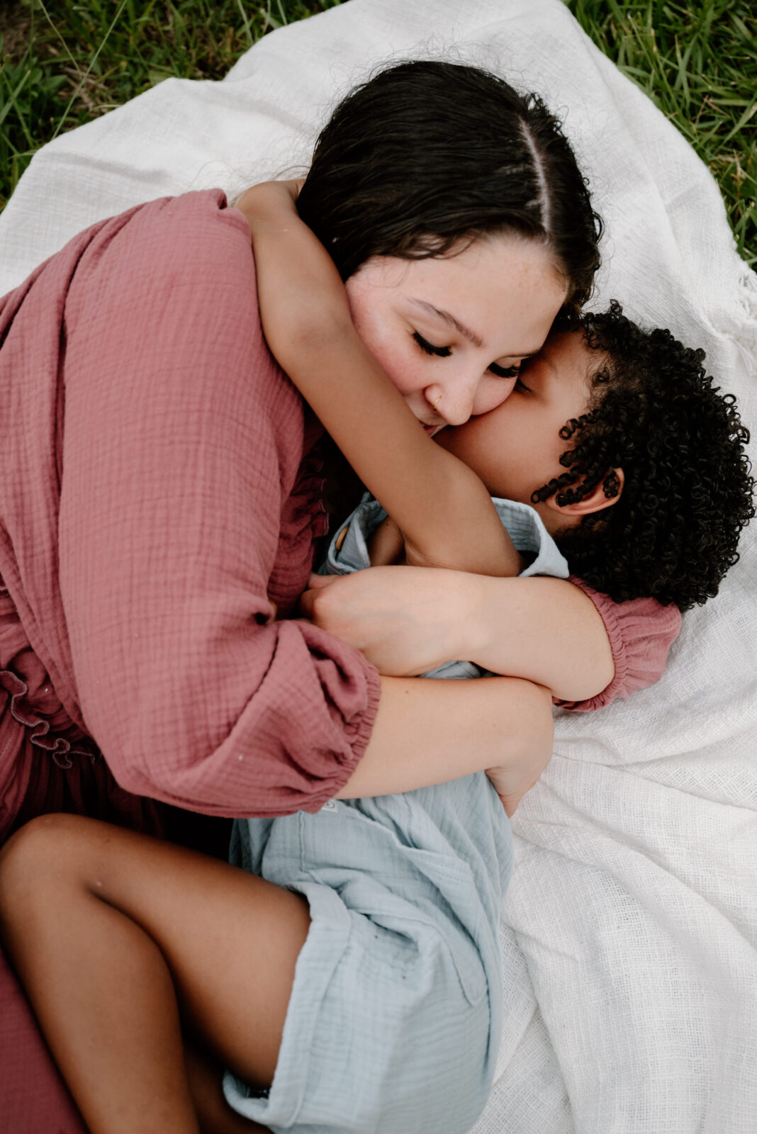 Mother and son cuddling during a stress-free lifestyle family photo session in Annapolis, capturing tender and emotional moments.